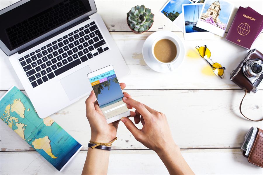 Phone and laptop over a travel planning desk